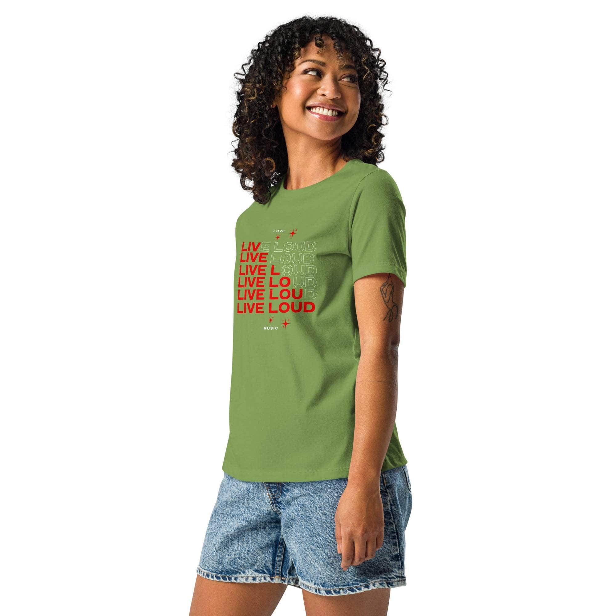 Woman wearing green LIVE LOUD Music T-Shirt with bold red retro typography and casual denim shorts