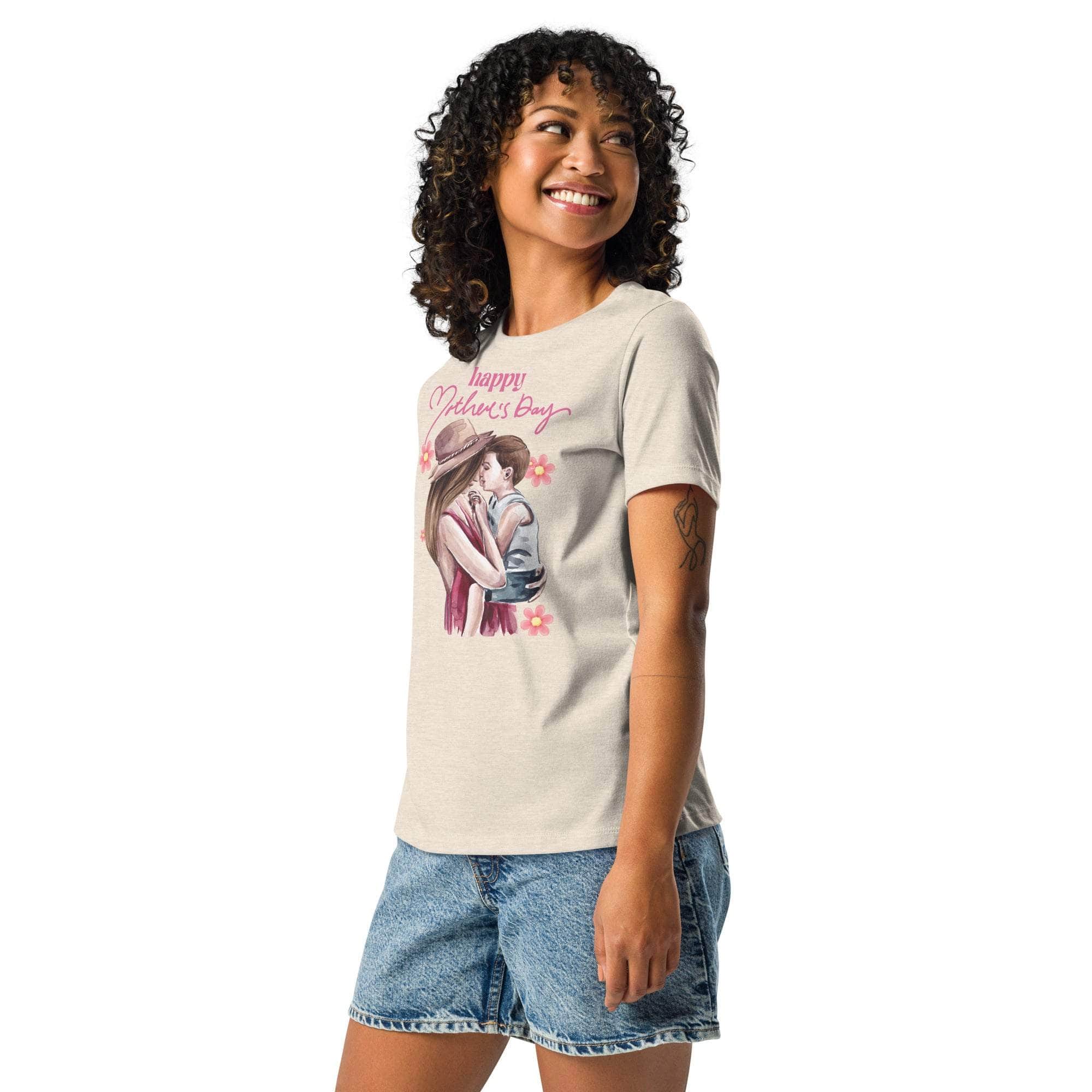 Woman wearing beige Mother's Day T-shirt with mom and child graphic and pink text, paired with denim shorts