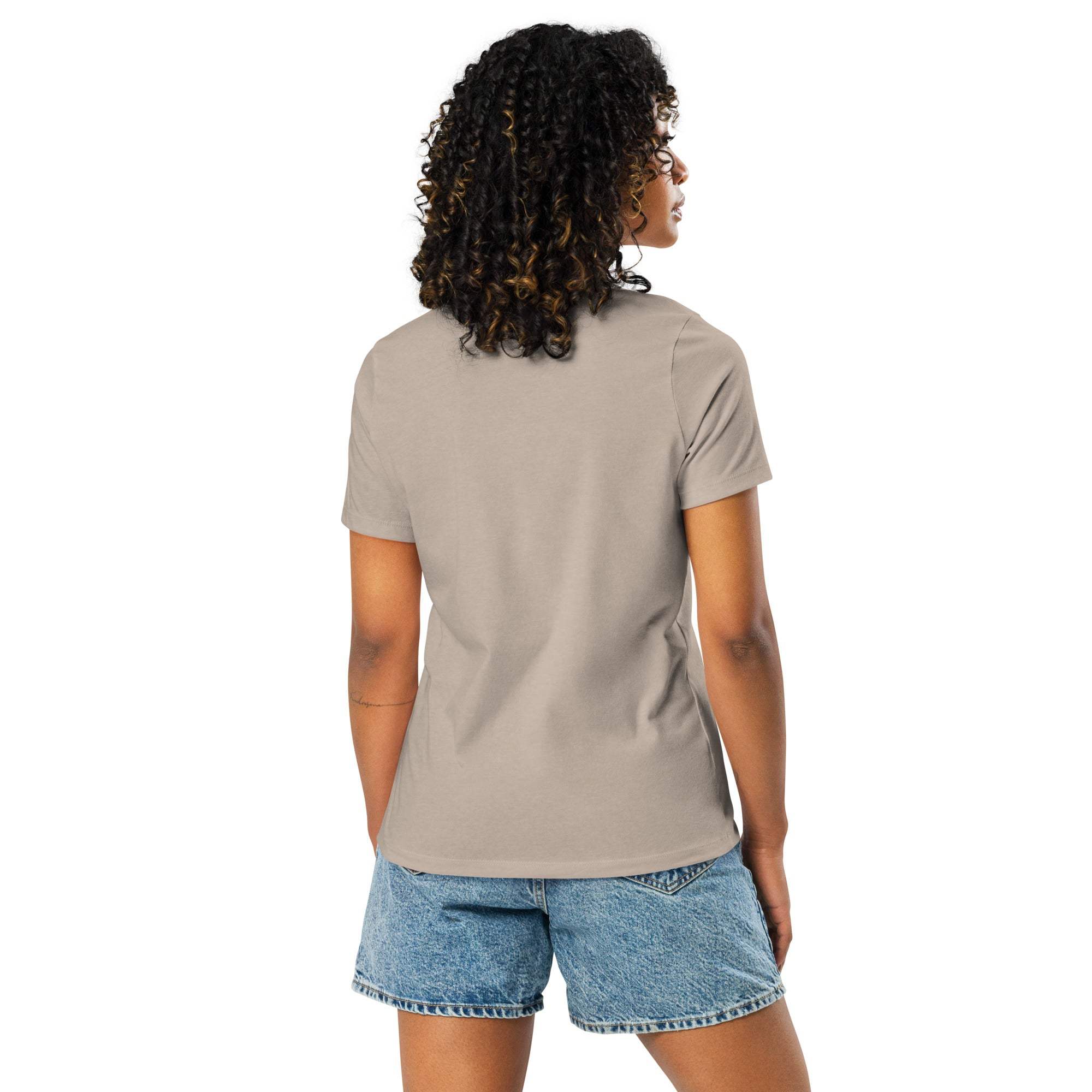Woman wearing beige "I'm Not Lazy, I am On Energy Saving Mode" sloth T-shirt and denim shorts, back view