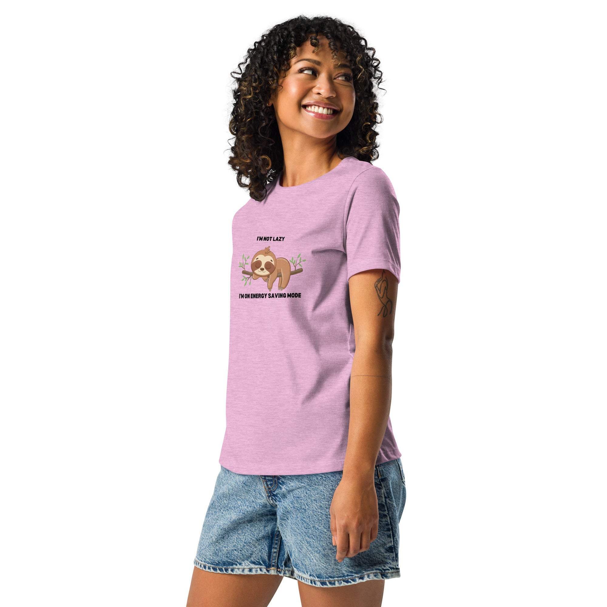 Woman wearing pink "I'm Not Lazy, I am On Energy Saving Mode" sloth graphic t-shirt with relaxed fit and denim shorts
