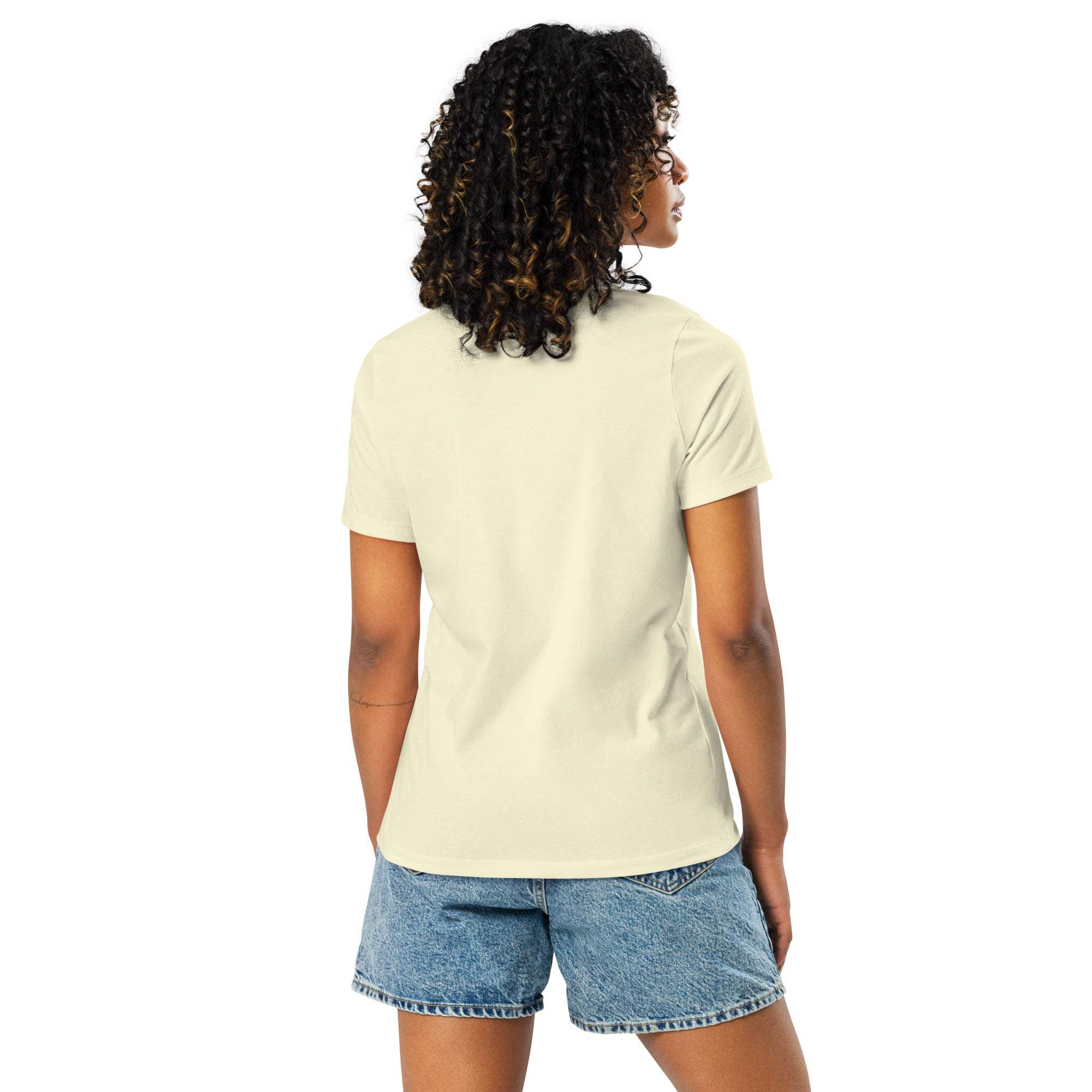Woman wearing beige "I'm Not Lazy, I am On Energy Saving Mode" sloth t-shirt and denim shorts, back view