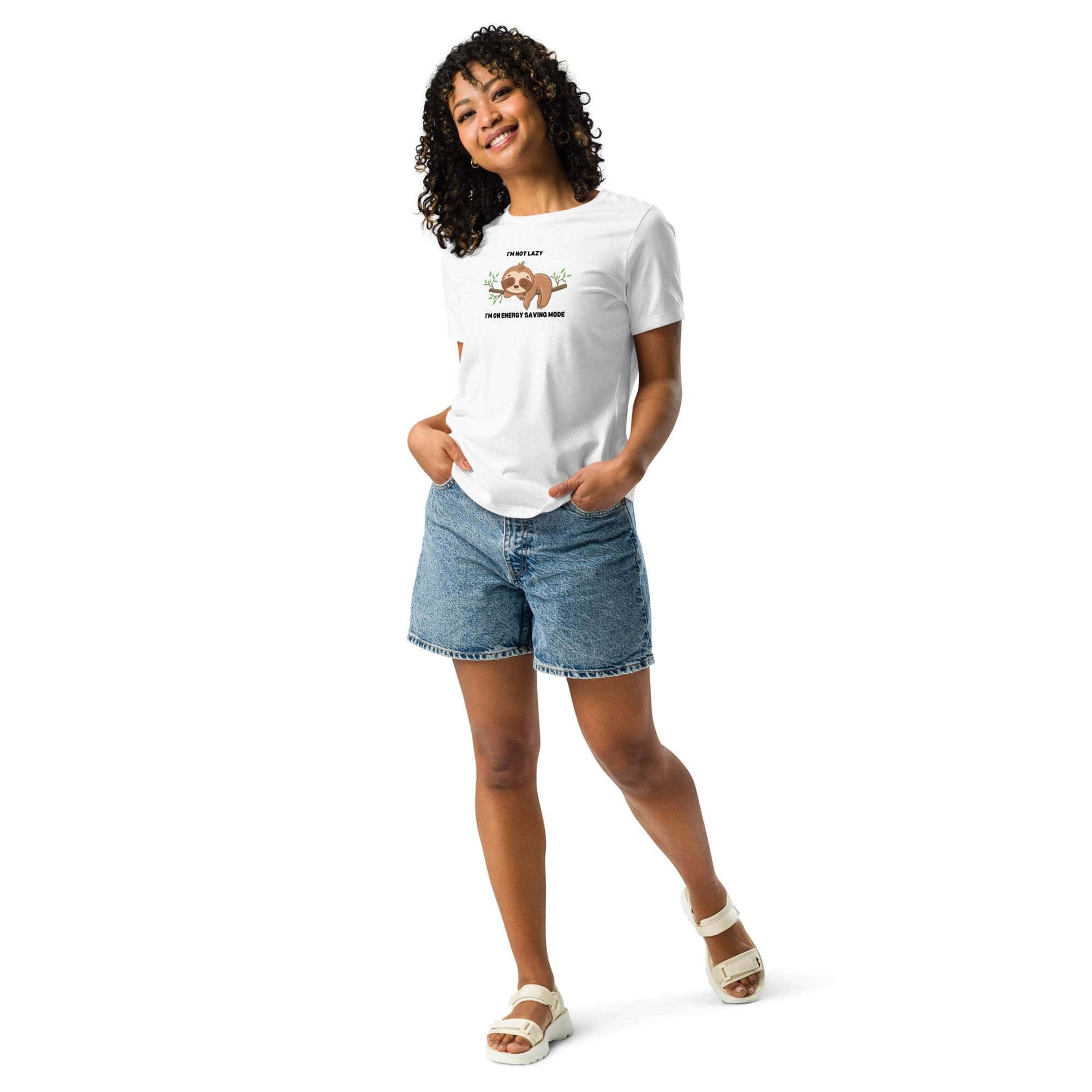 Woman wearing white "I'm Not Lazy, I Am On Energy Saving Mode" sloth graphic t-shirt with denim shorts and sandals