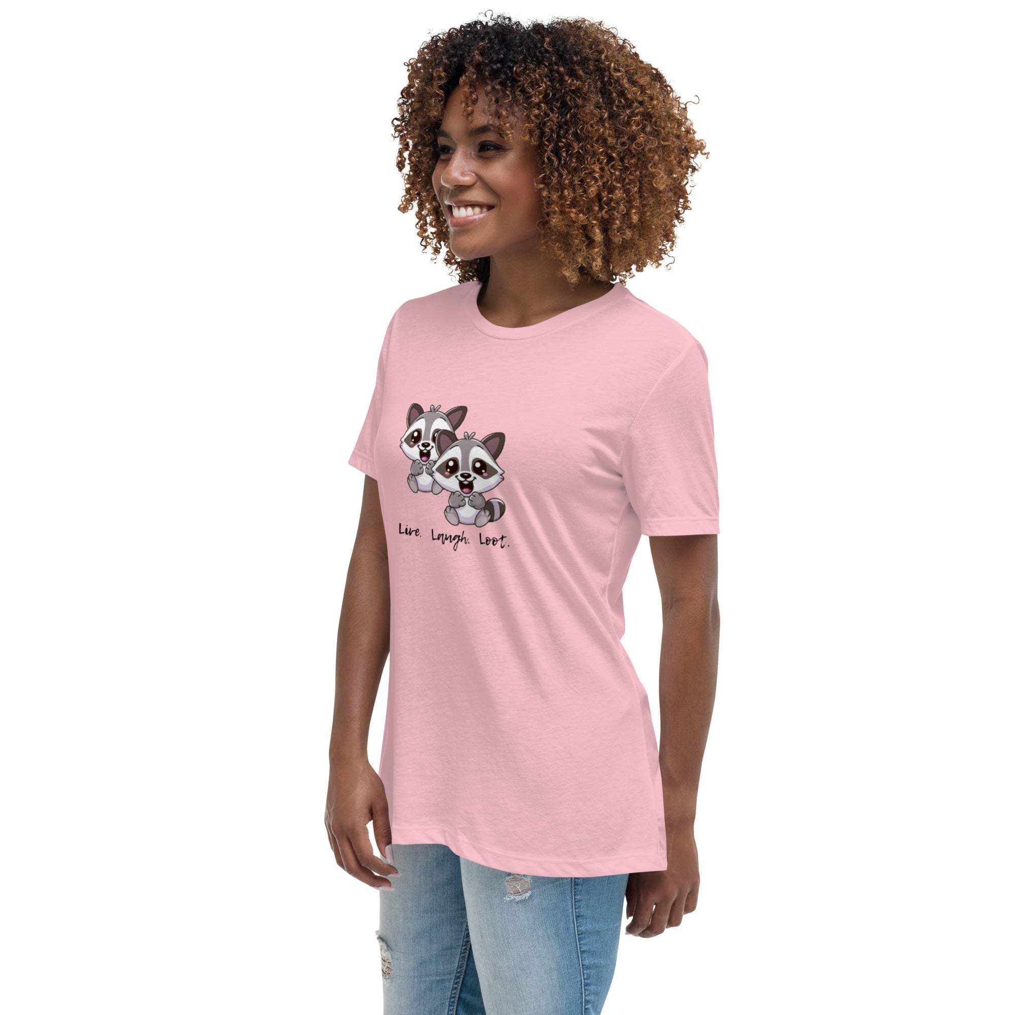 Woman wearing pink Live Laugh Loot T-Shirt with cute raccoon design and text, paired with light blue jeans
