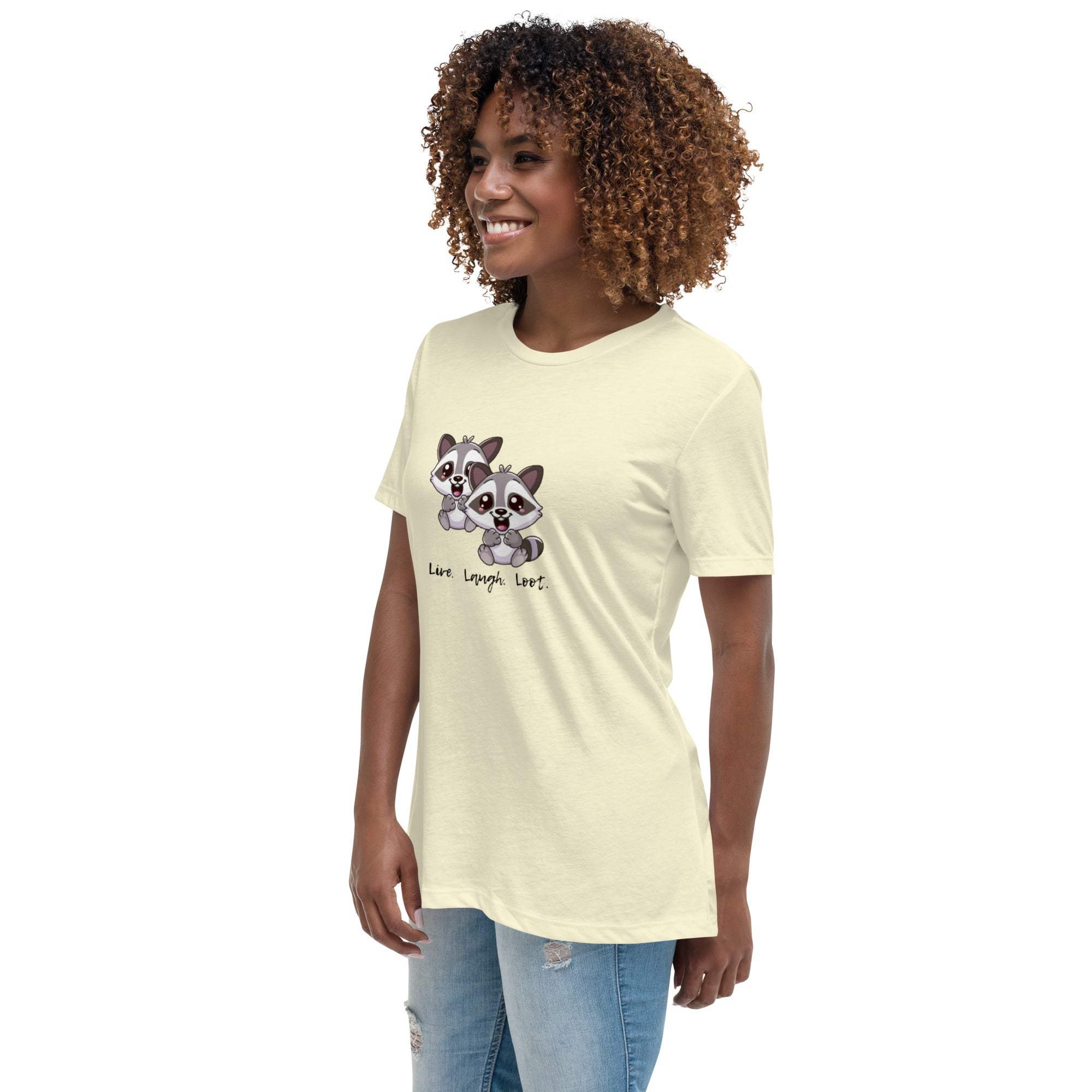 Woman wearing a cream Live Laugh Loot T-Shirt with a cute raccoon graphic and casual jeans