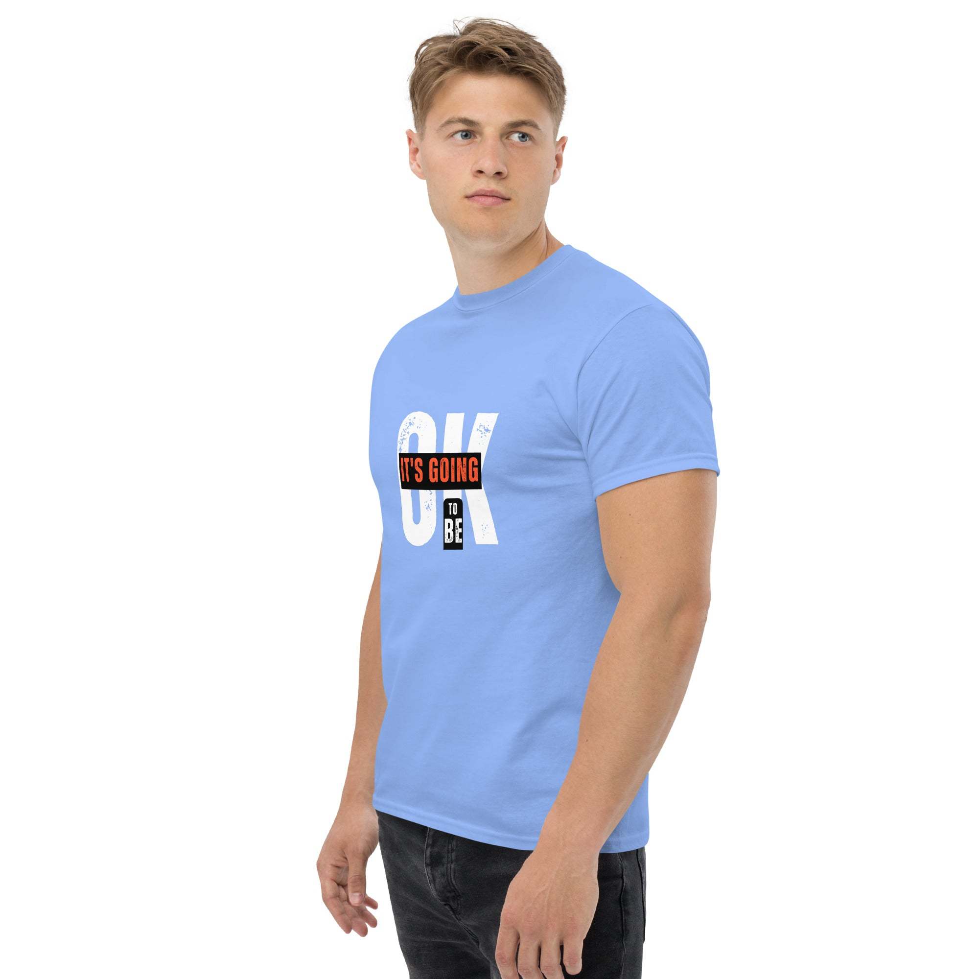 Man wearing blue trendy graphic t-shirt with motivational quote and casual black pants
