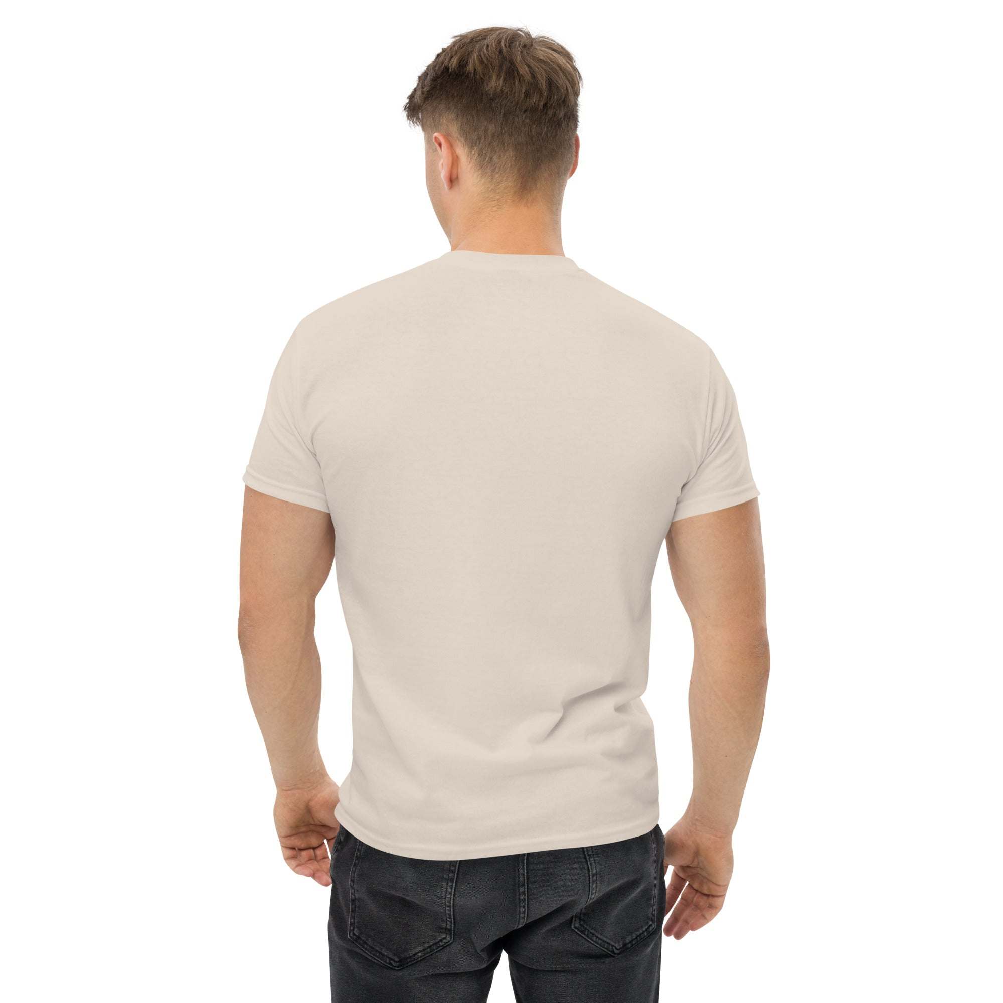 Back view of man wearing plain beige trendy graphic t-shirt paired with black jeans