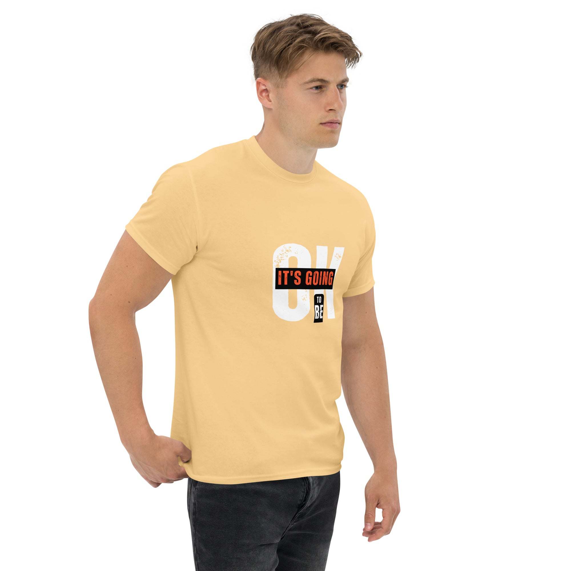 Man wearing beige trendy graphic t-shirt with motivational quote print, styled with black jeans, casual streetwear summer look
