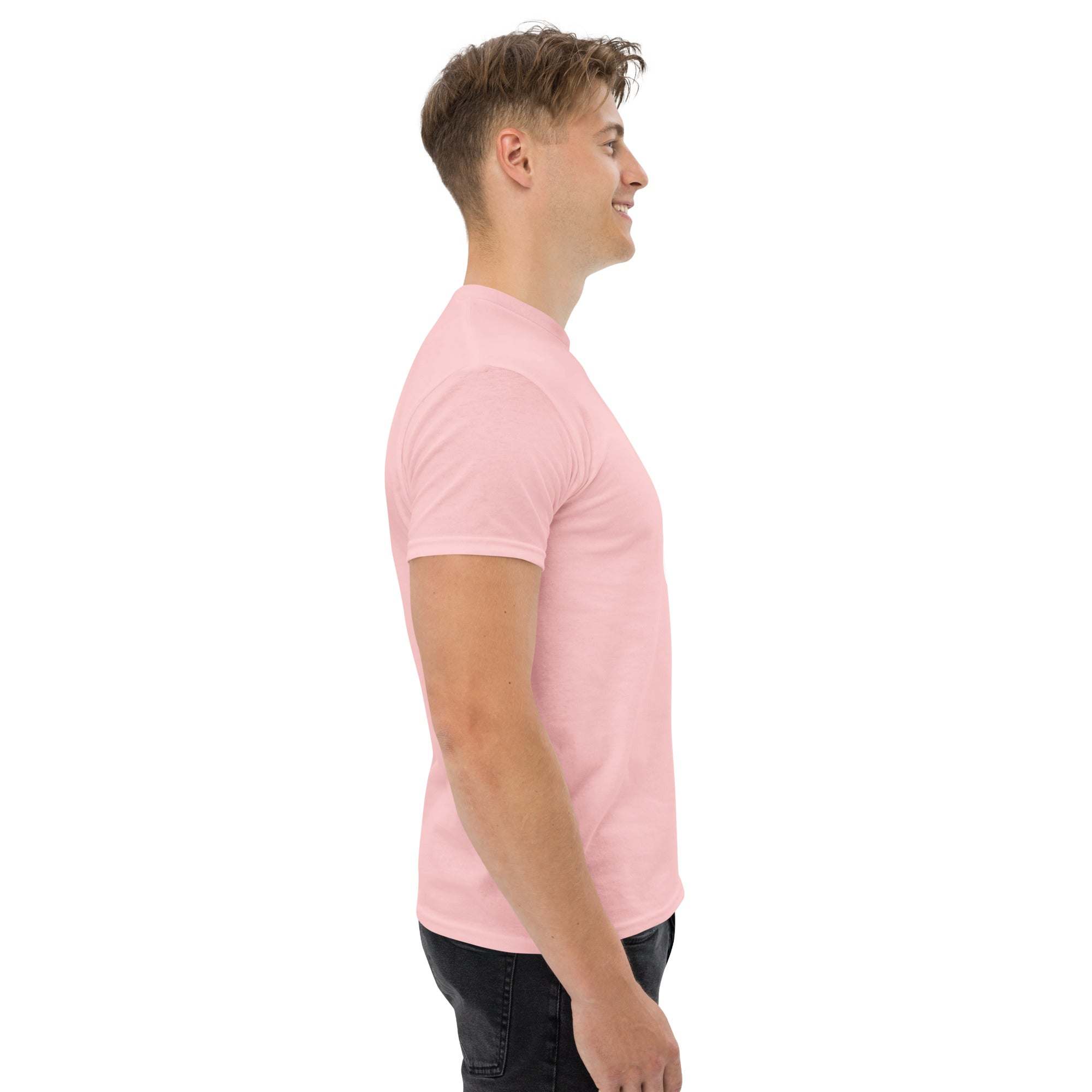 Side view of man wearing pink trendy graphic t-shirt with motivational quote print in casual streetwear style