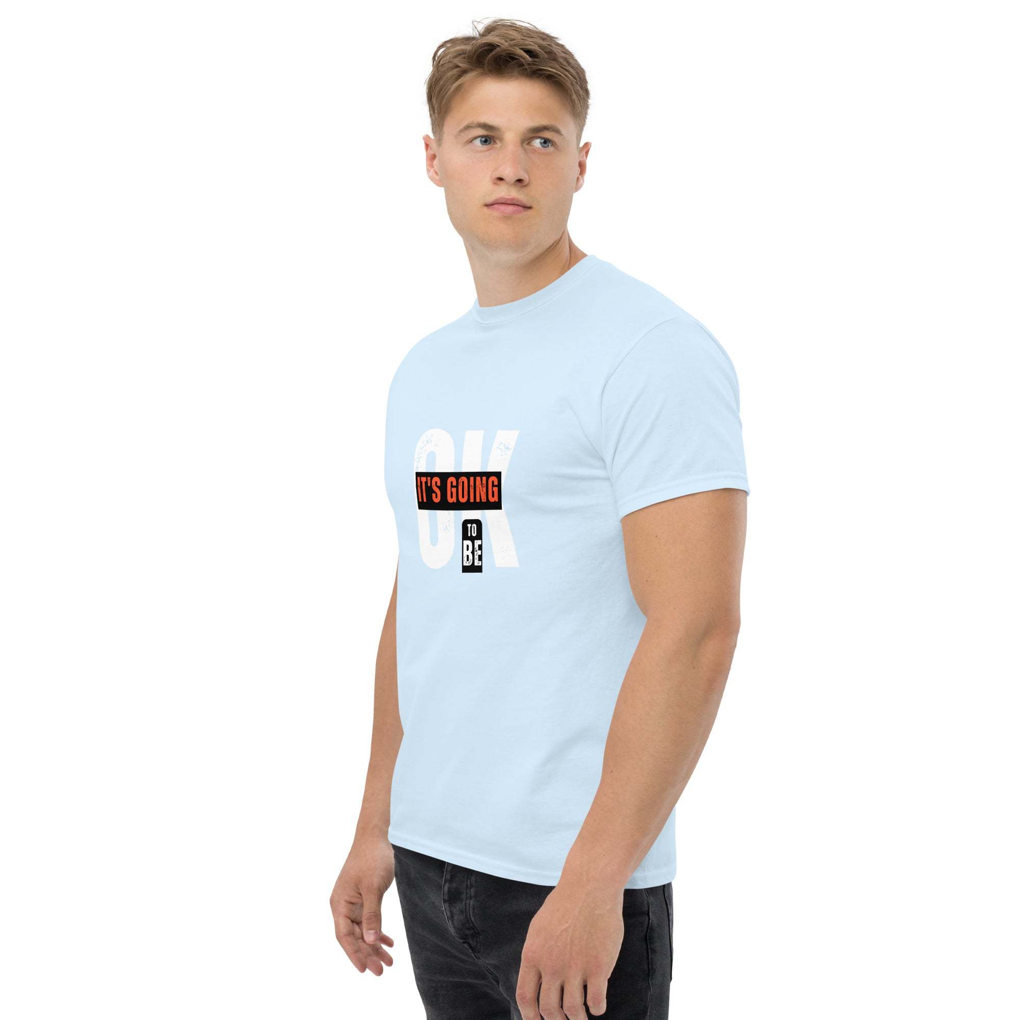 Man wearing light blue trendy graphic t-shirt with motivational quote print and casual streetwear style
