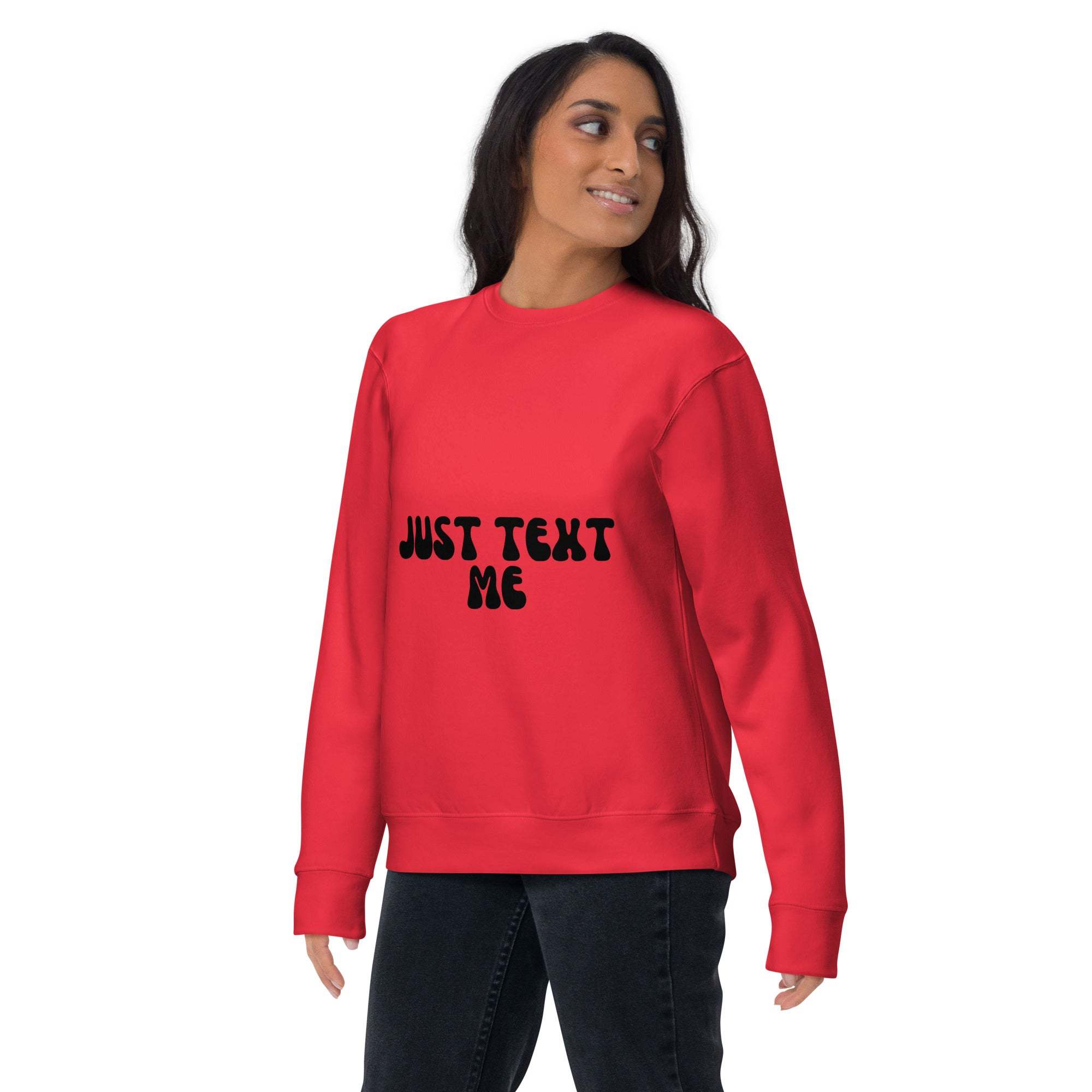 Woman wearing red casual unisex "Just Text Me" sweatshirt with black text on front, paired with black pants.