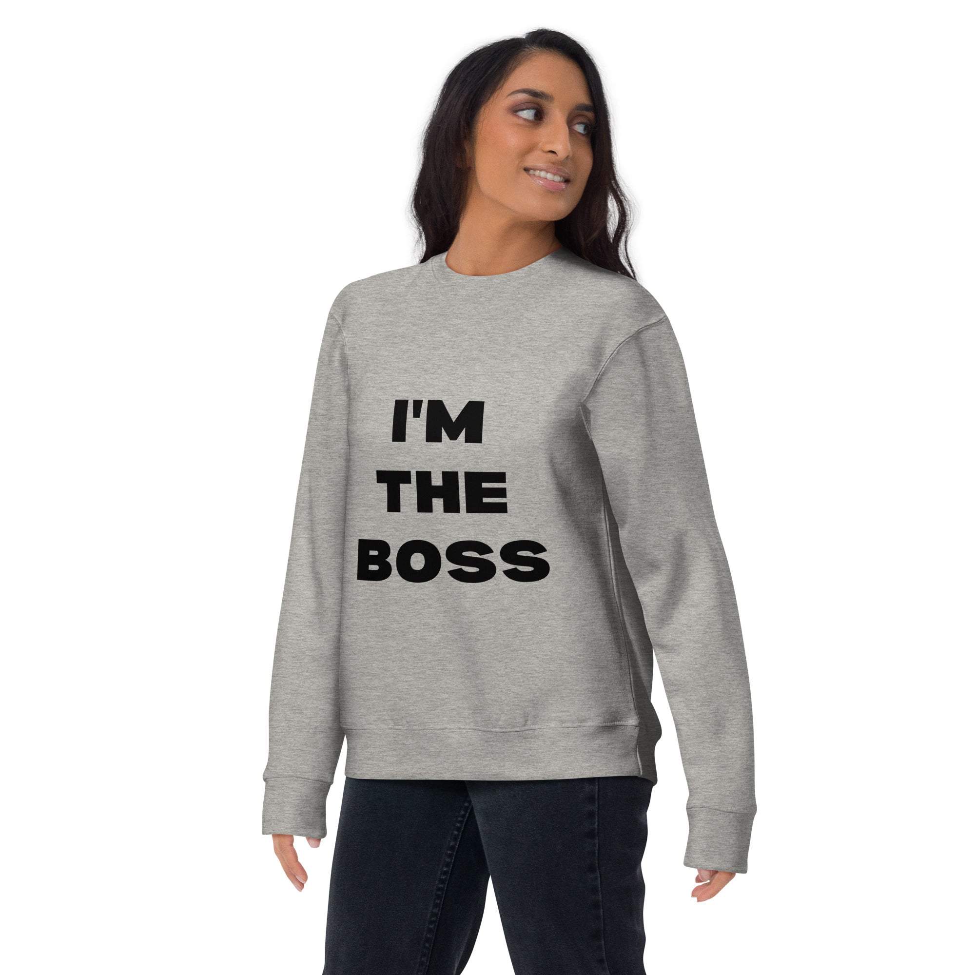 Woman wearing gray crewneck sweatshirt with bold black text I'm The Boss, casual confident style