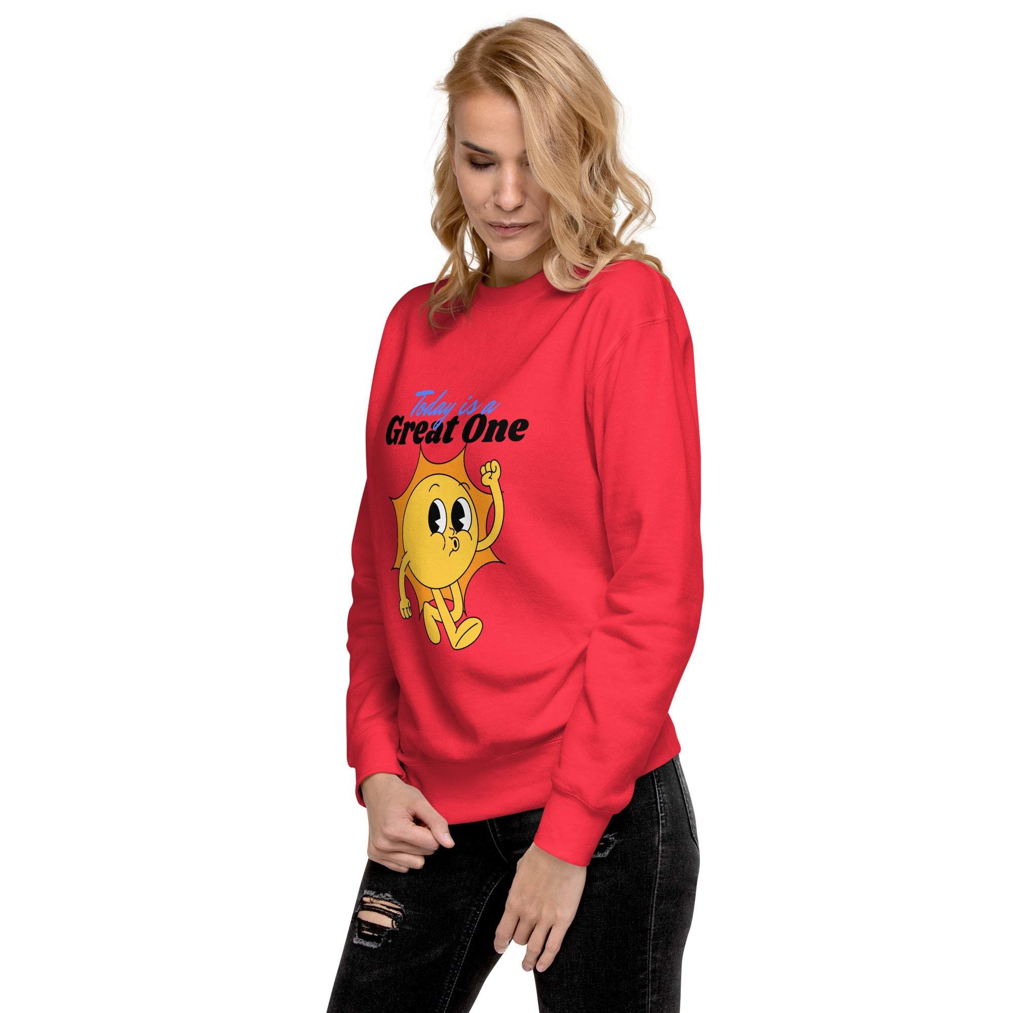 Woman wearing bright red Positive Sun Sweatshirt with cheerful sun graphic and motivational text