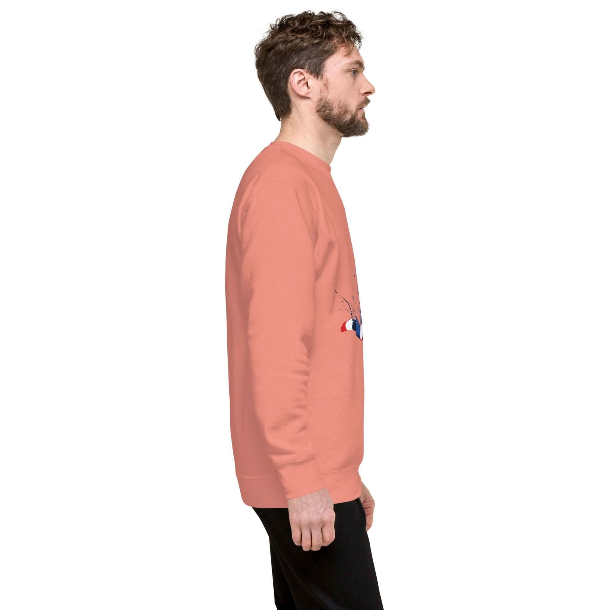 Side view of a man wearing a coral Soccer Player Sweatshirt with a sports graphic and black pants