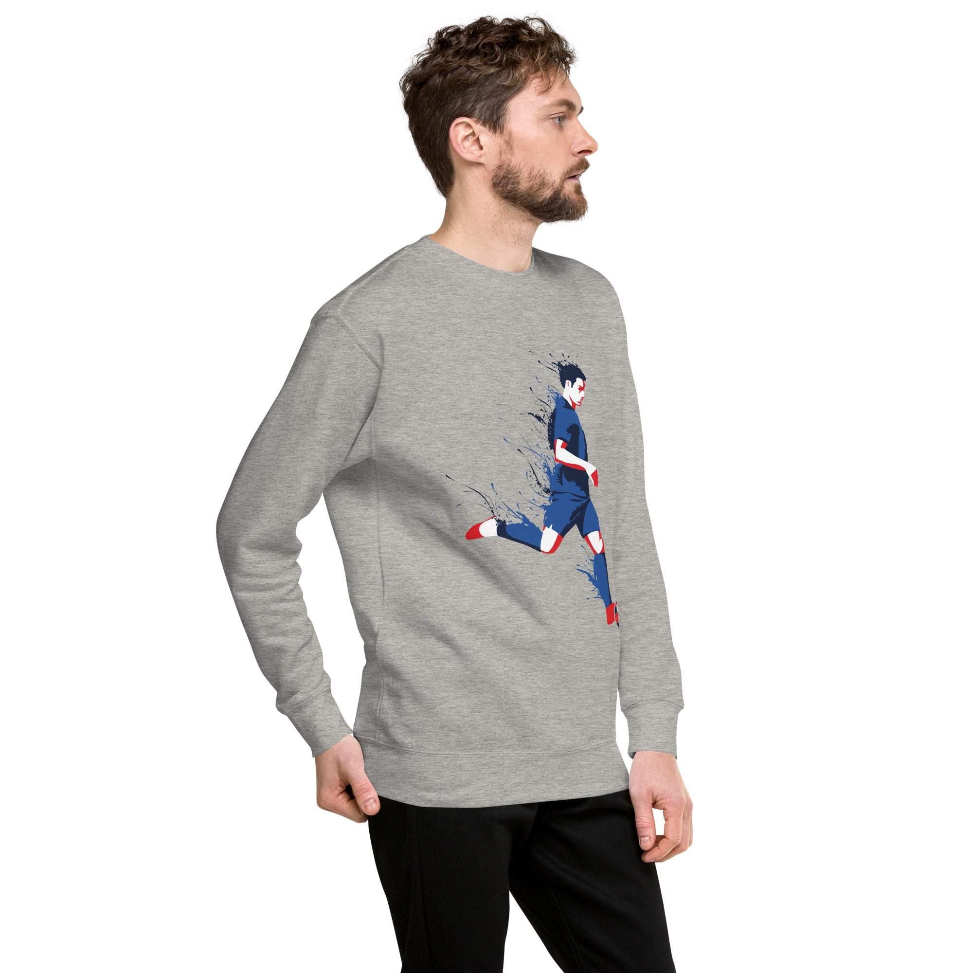 Man wearing gray soccer player sweatshirt with graphic print and black pants