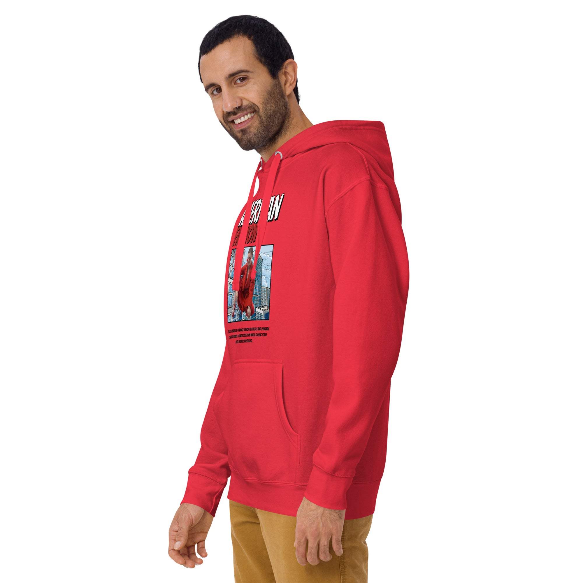 Man wearing red vintage American fashion hoodie with urban graphic print and beige pants smiling sideways