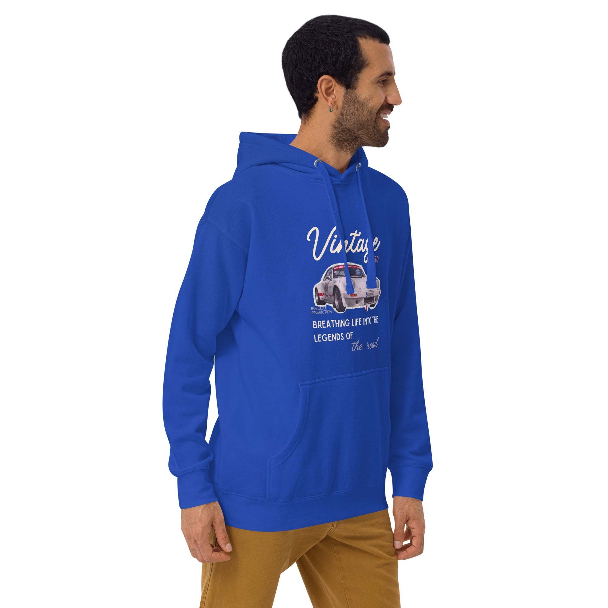 Blue vintage car hoodie with classic car graphic and script design, worn by a smiling man