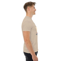 Side view of a man wearing beige Rocket Ride T-Shirt with retro cartoon space adventure graphic, unisex fit