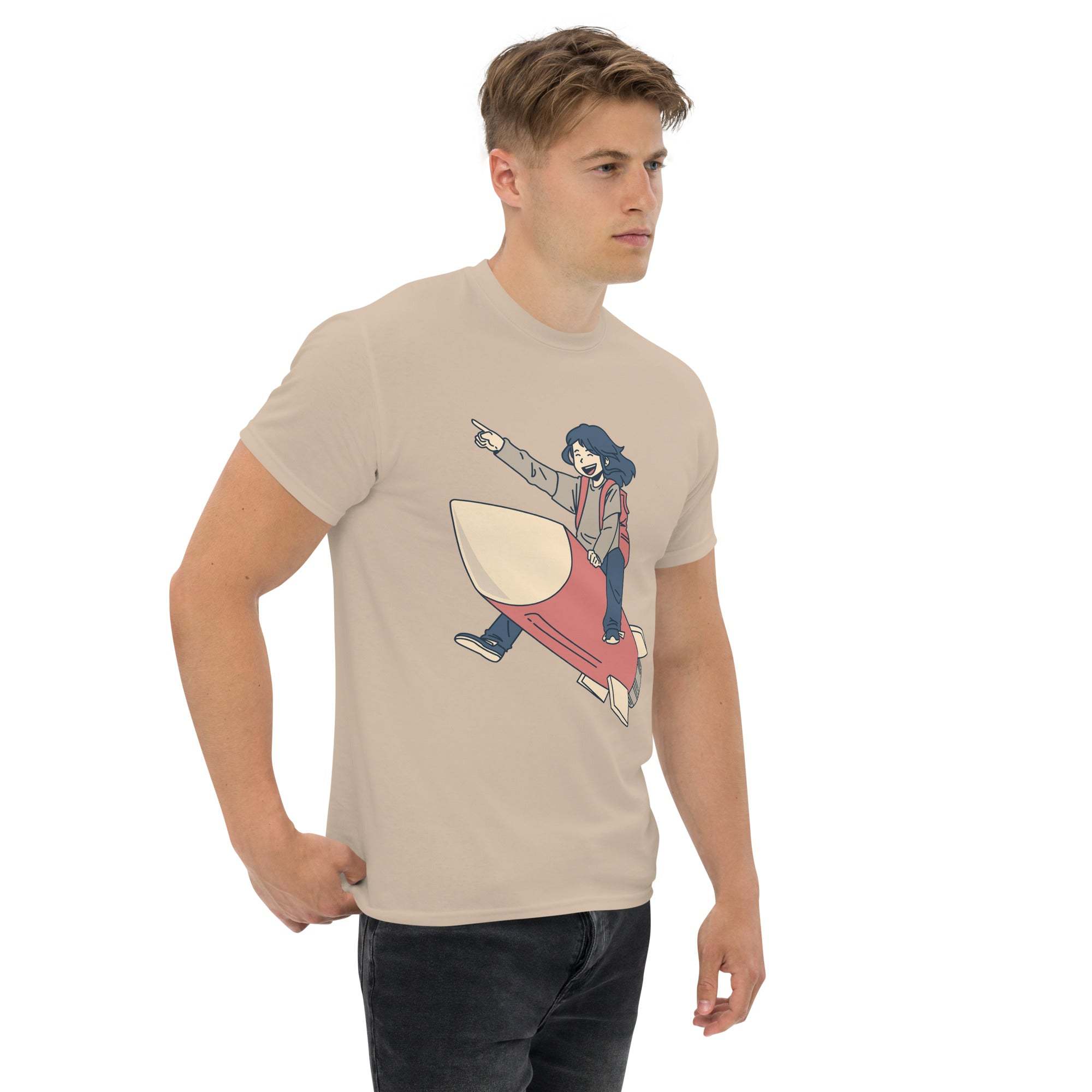Man wearing beige Rocket Ride T-Shirt with retro cartoon rocket and astronaut graphic, unisex fit.