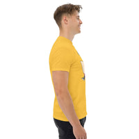 Side view of man wearing yellow Rocket Ride T-Shirt with retro cartoon astronaut graphic