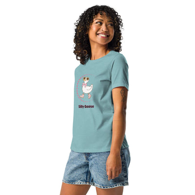 Woman wearing a blue Silly Goose Graphic T-Shirt with a playful illustrated goose and text, paired with denim shorts.